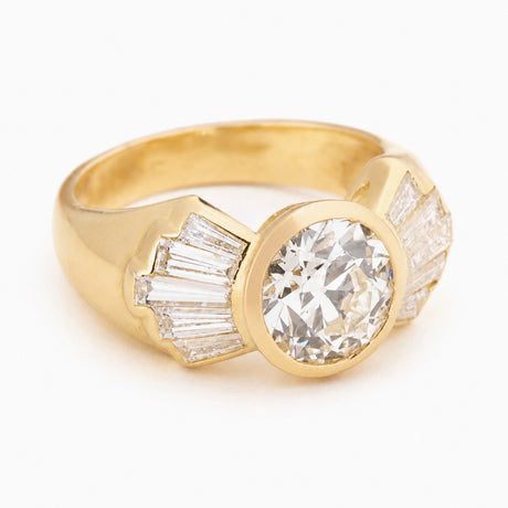 Vintage 1950s old-cut diamond fan engagement ring with wide gold band and tapered diamonds.