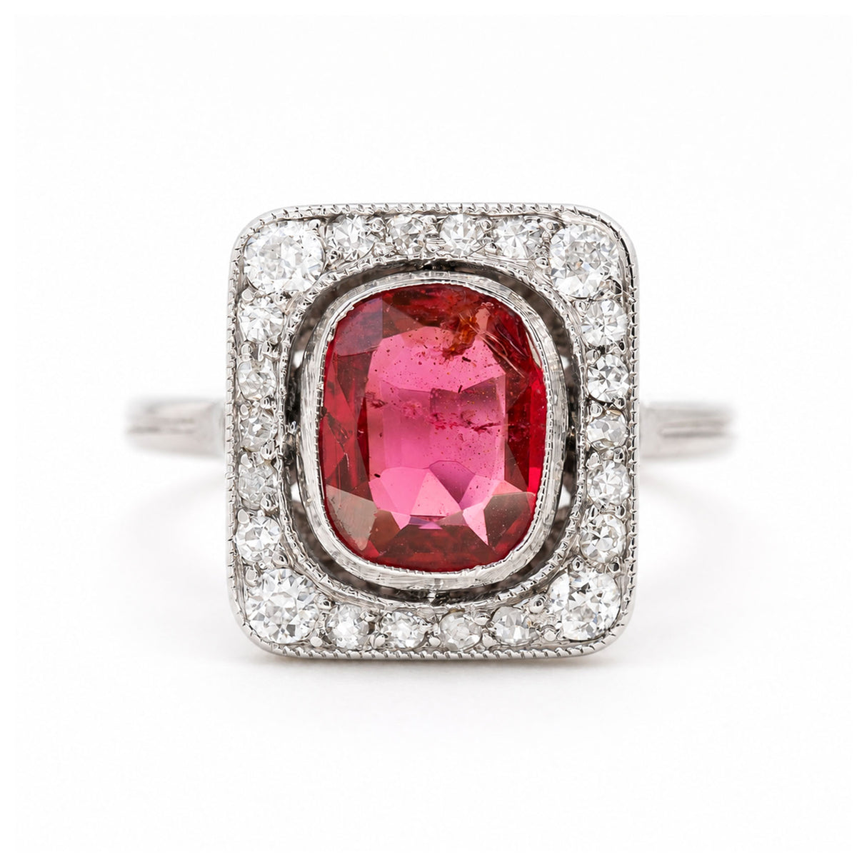 A close up of an antique, Art Deco saturated red spinel and diamond cluster ring in platinum.