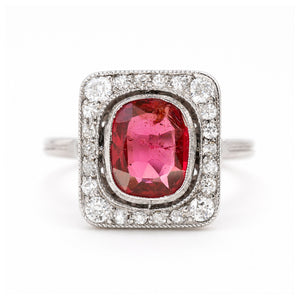 A close up of an antique, Art Deco saturated red spinel and diamond cluster ring in platinum.