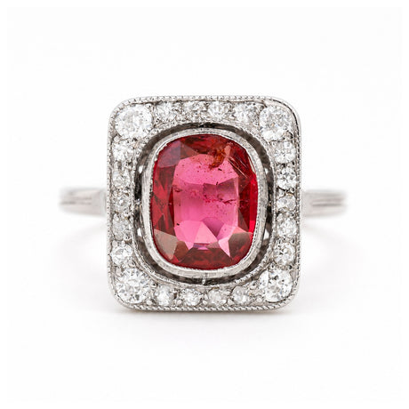 A close up of an antique, Art Deco saturated red spinel and diamond cluster ring in platinum.
