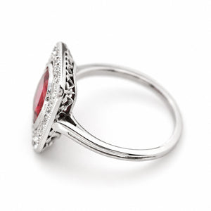 A side profile of an antique, Art Deco red spinel and diamond cluster ring set in platinum.