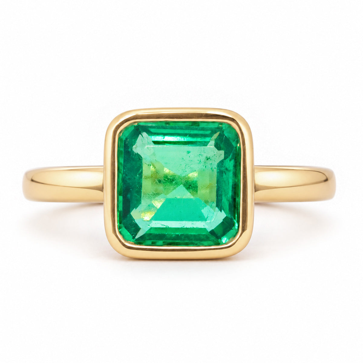 Antique-inspired Colombian emerald solitaire engagement ring in yellow gold, featuring a square emerald-cut stone in a smooth rub-over setting.