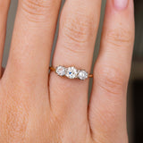 A close up picture of an Antique, Edwardian diamond trilogy yellow gold engagement ring