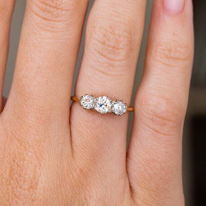 A close up picture of an Antique, Edwardian diamond trilogy yellow gold engagement ring