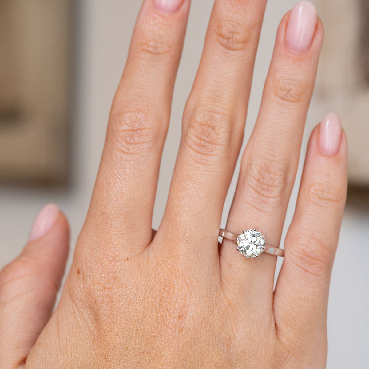 Art Deco old-cut diamond engagement ring worn on the hand, displaying its elegant proportions and warm sparkle.