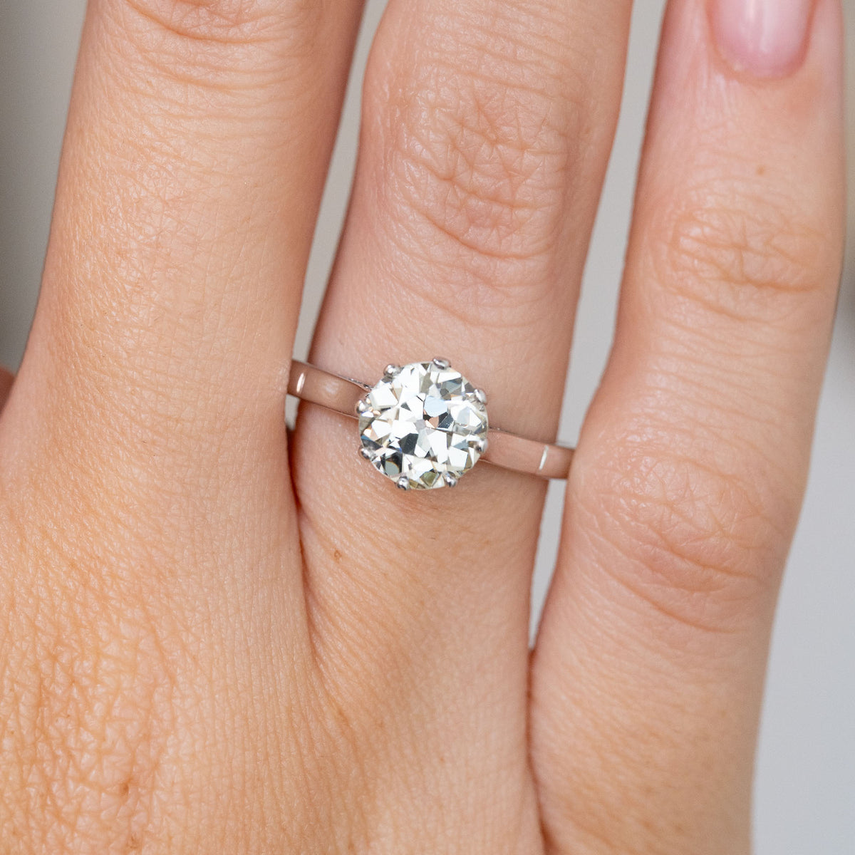 Close-up of the Art Deco engagement ring, featuring a substantial old-cut diamond in a classic claw setting.