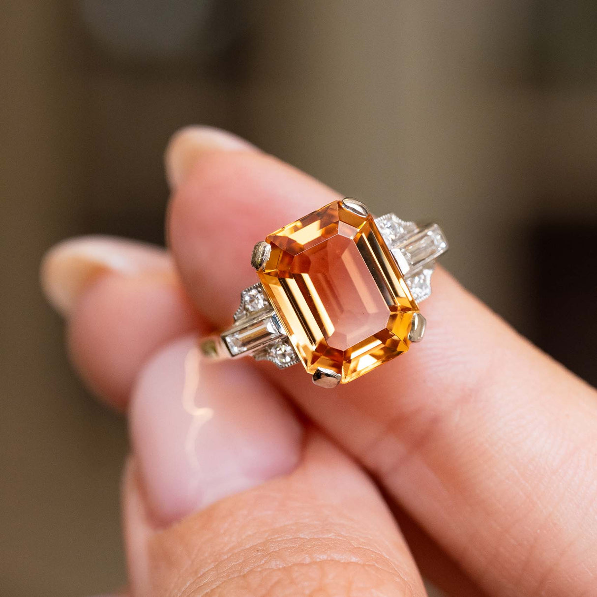 A close-up of a hand holding a Vintage, 1950s Sherry topaz and diamond cocktail ring