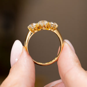 Profile view of a vintage 1930s diamond engagement ring, displaying the open claw gallery and polished 18ct yellow gold band.