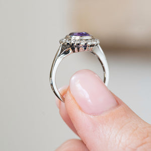 The side profile displays the elevated platinum gallery and graceful white gold band supporting the antique gemstone cluster.