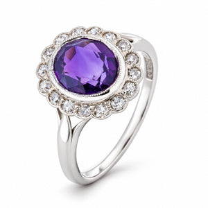 Studio three-quarter view revealing the deep purple amethyst, old-cut diamond halo and elegantly split white gold shoulders.