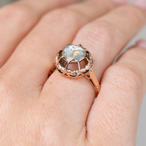Seen from an oblique angle, the ring reveals its elevated rose-cut diamond and sculptural pierced gold gallery.
