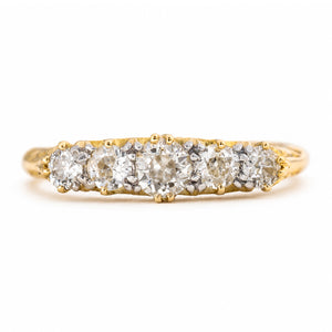 An Antique Victorian, yellow gold diamond ring featuring five diamonds set in a row, photographed on a clean white background.