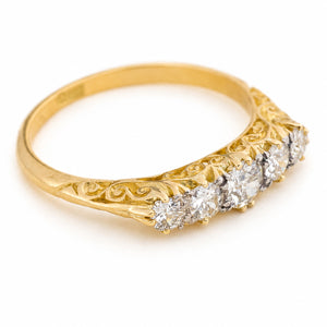 A yellow gold five-stone Antique Victorian diamond ring with an ornate filigree band, photographed on a clean white background.
