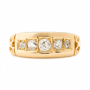 An Antique, Victorian diamond five-stone engagement ring in yellow gold shown against a plain white background.