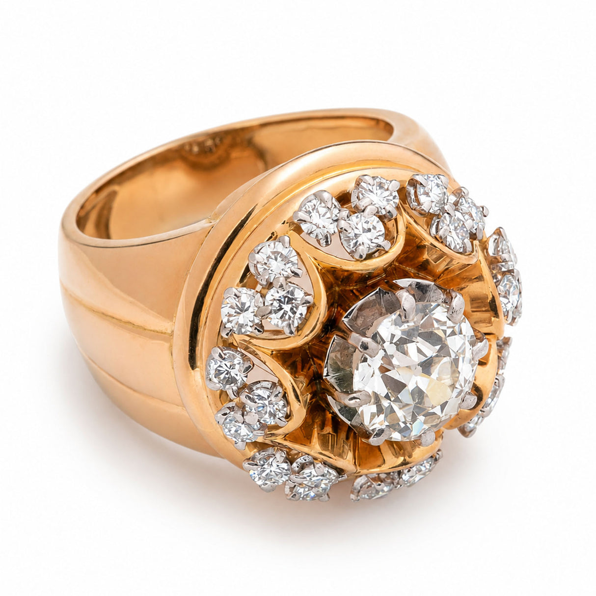 A Vintage, 1960s French cocktail ring set with old cut diamonds in a fluted yellow gold setting and yellow gold band.  Photographed against a plain white background. 