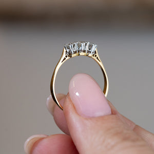 Side profile of the antique Edwardian engagement ring, revealing the open gallery, platinum claws and polished yellow gold band.