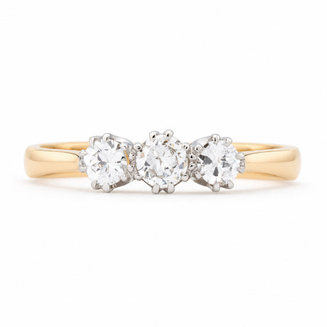 Antique Edwardian old-cut diamond three-stone engagement ring in yellow gold and platinum, featuring three round diamonds in claw settings.