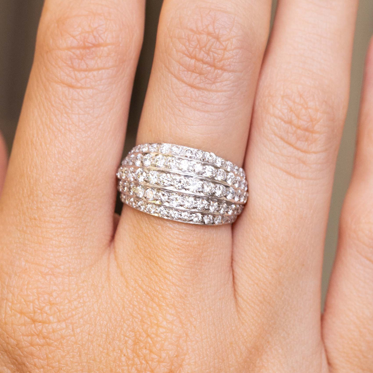 detailed image of A Vintage, 1950s diamond bombe cocktail ring in white gold worn on the finger