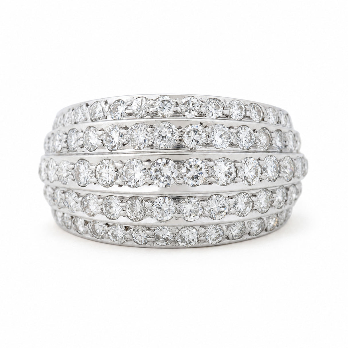A Vintage, 1950s diamond bombe cocktail ring in white gold against a white background