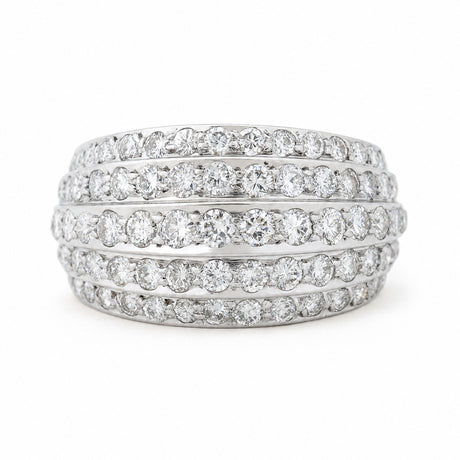 A Vintage, 1950s diamond bombe cocktail ring in white gold against a white background