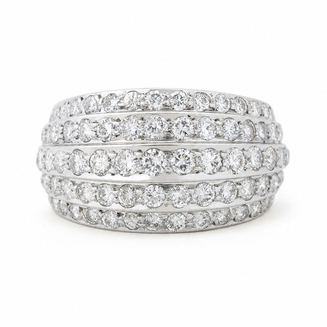 A Vintage, 1950s diamond bombe cocktail ring in white gold against a white background