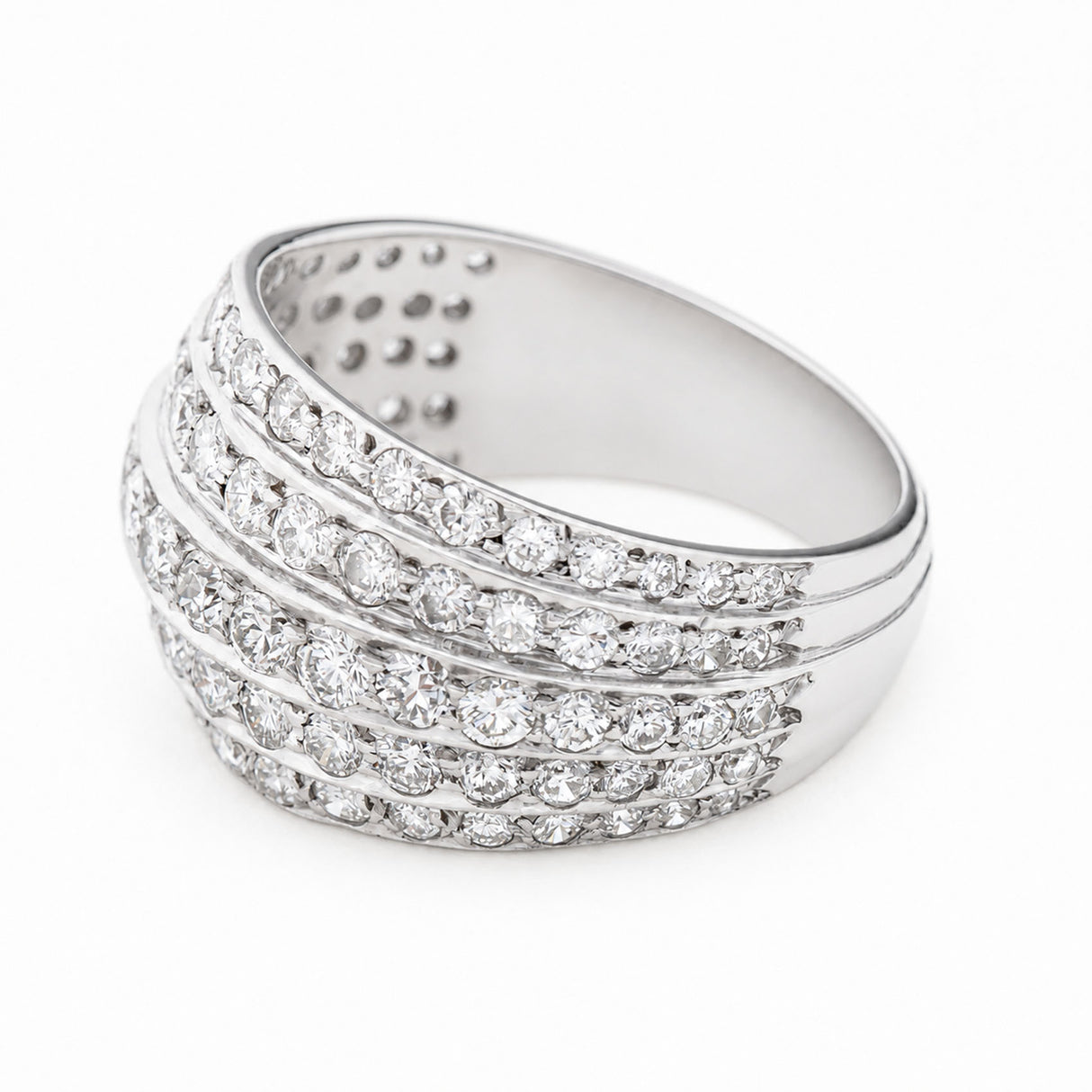 A Vintage, 1950s diamond bombe cocktail ring in white gold turned to the side to show the band against a white background