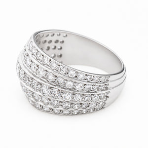 A Vintage, 1950s diamond bombe cocktail ring in white gold turned to the side to show the band against a white background