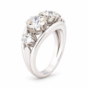 Angled view of the vintage diamond ring, highlighting the raised claw settings and distinctive openwork design.