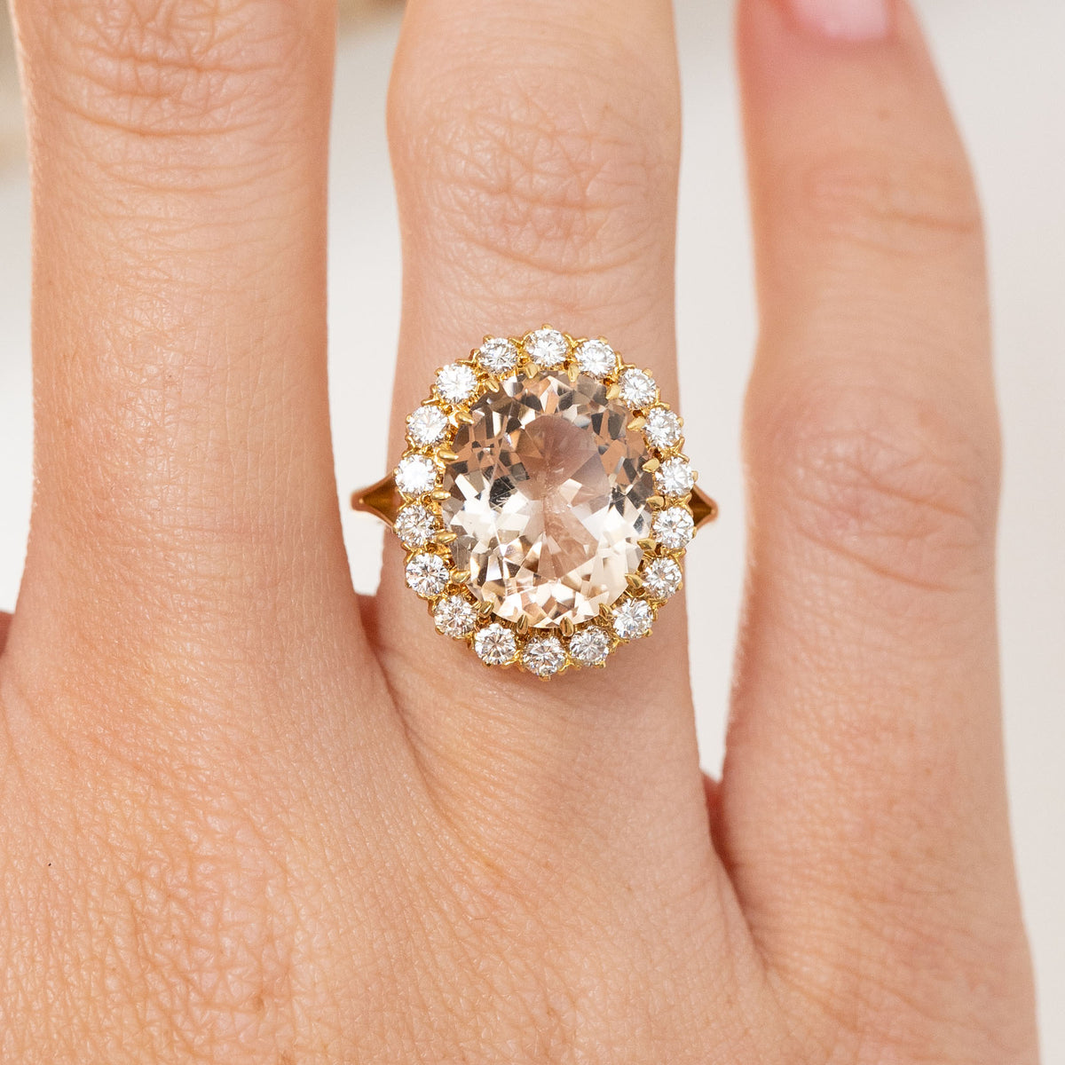 Close-up of the vintage cluster ring, highlighting the softly coloured topaz and bright round diamond surround.
