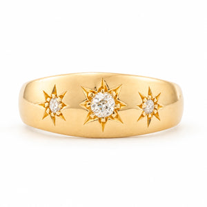 An Antique, Edwardian diamond three-stone gypsy ring yellow gold on a white background