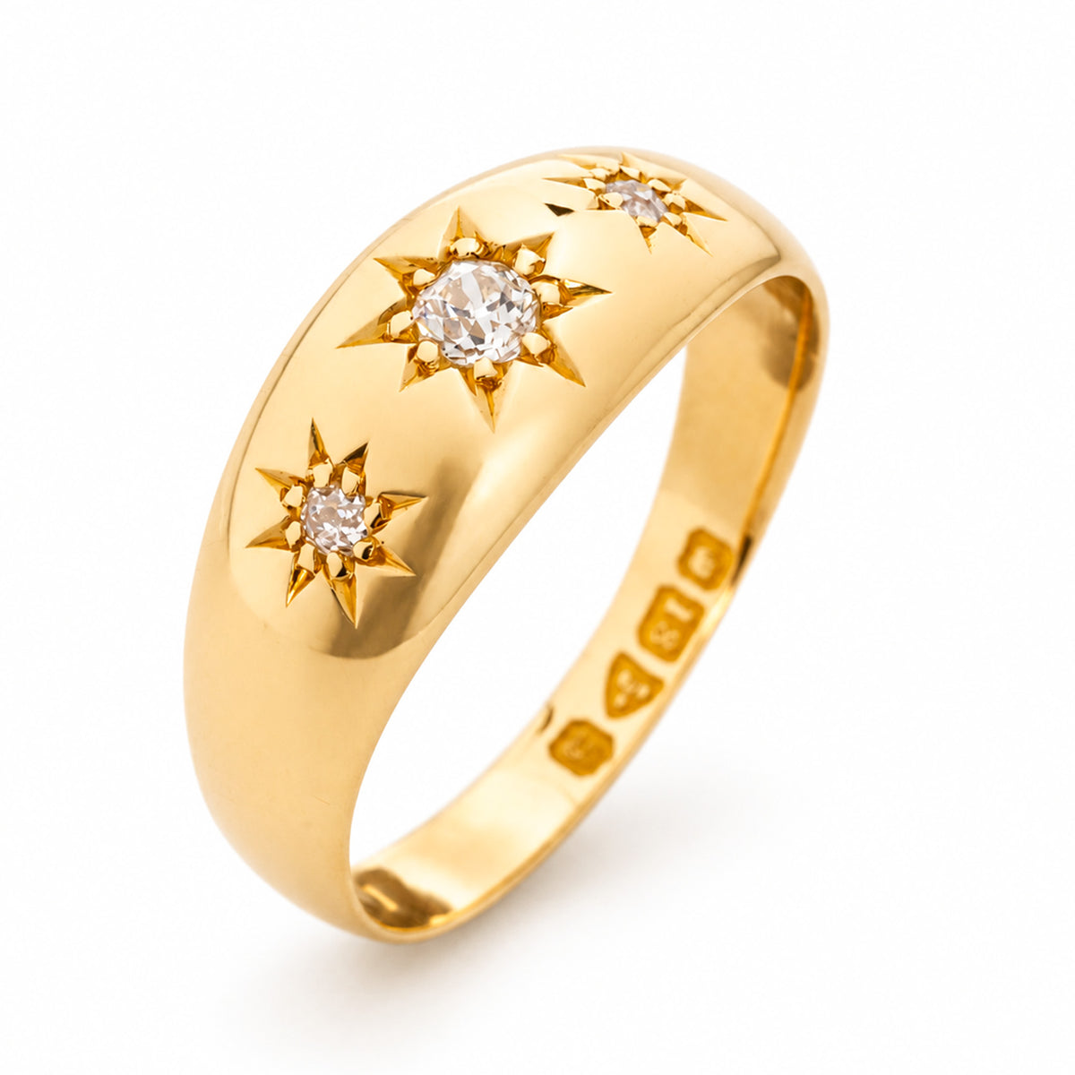 Antique, Edwardian diamond gold three-stone gypsy ring with star settings and hallmarks shown from an upright angle