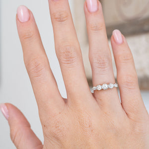 Modelled on the hand, the graduated diamond arrangement curves gracefully across the finger in a classic Edwardian design.