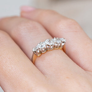 An oblique worn perspective reveals the elevated row of five diamonds and the contrasting yellow gold under-gallery.