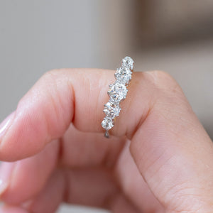 Held vertically between the fingers, the ring displays the individual old-cut diamond shapes and handcrafted claw settings.