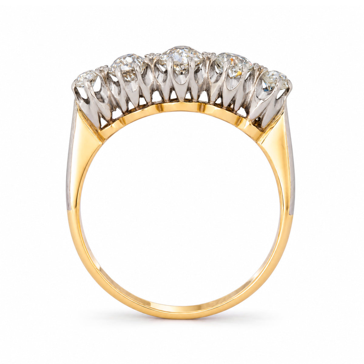 Viewed from the reverse, the antique five-stone ring reveals its arched platinum gallery and warm yellow gold shank.