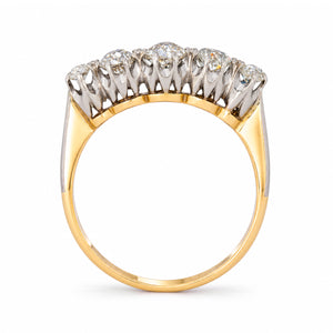 Viewed from the reverse, the antique five-stone ring reveals its arched platinum gallery and warm yellow gold shank.