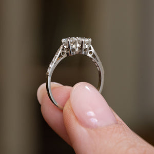 Profile view of the antique Art Deco engagement ring, displaying the open gallery beneath the twin diamonds and fine platinum shank.