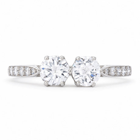 Antique Art Deco diamond toi et moi engagement ring in platinum, set with two round transition-cut diamonds and diamond-set shoulders.