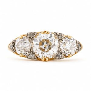 Front view of a c.1890 Victorian engagement ring, featuring three graduated old-cut diamonds with rose-cut diamond accents in 18ct yellow gold.