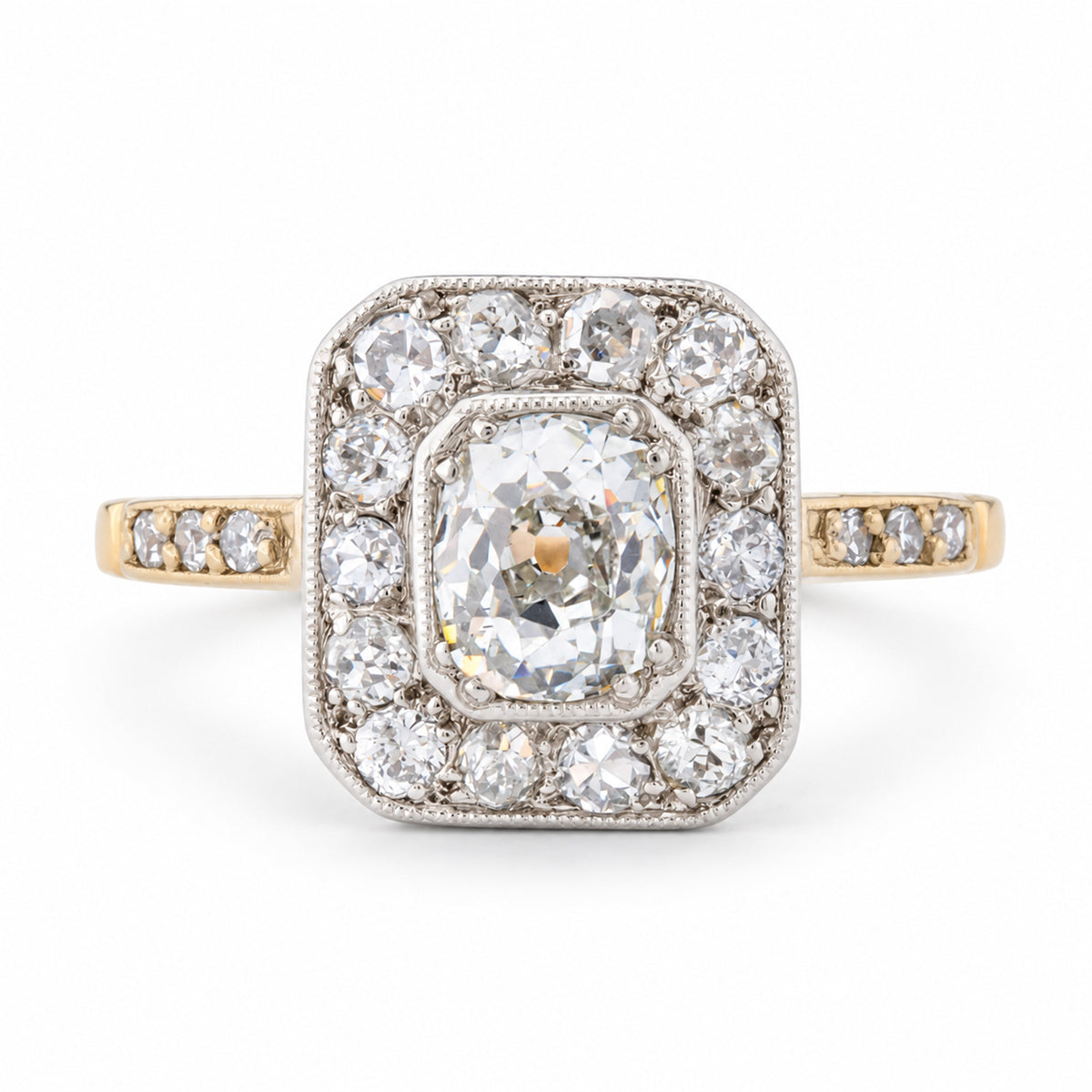 Front view of an antique Edwardian old-mine cut diamond cluster engagement ring in yellow gold and platinum.