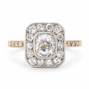 Front view of an antique Edwardian old-mine cut diamond cluster engagement ring in yellow gold and platinum.