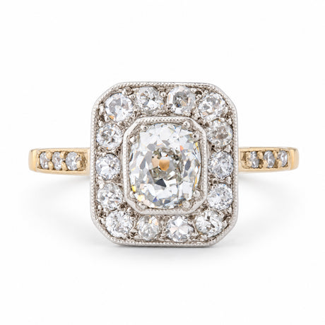 Front view of an antique Edwardian old-mine cut diamond cluster engagement ring in yellow gold and platinum.