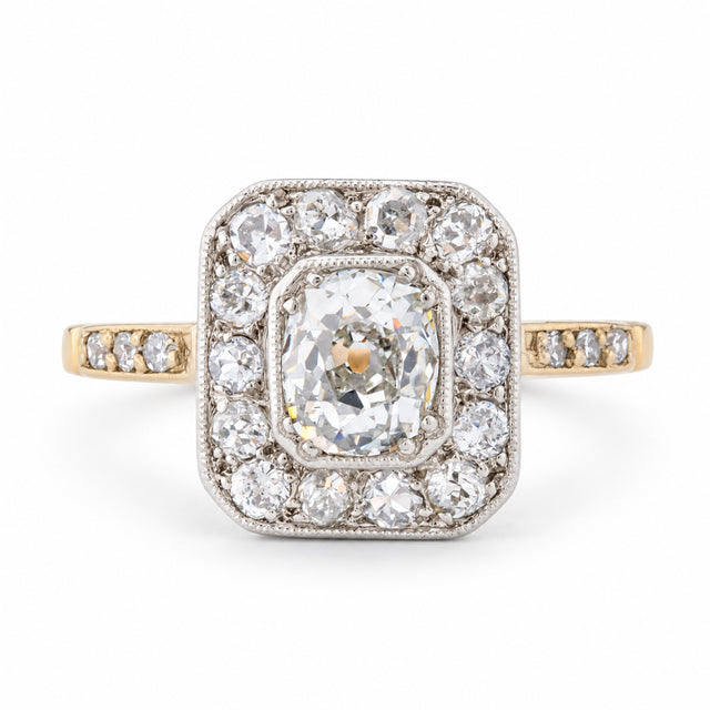 Front view of an antique Edwardian old-mine cut diamond cluster engagement ring in yellow gold and platinum.