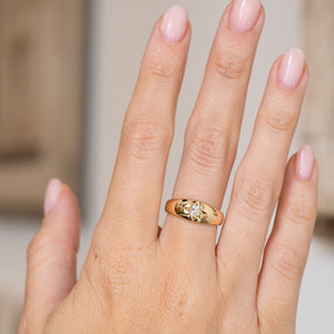 Antique yellow gold diamond ring worn on the hand, displaying the bold proportions of its classic gypsy design.