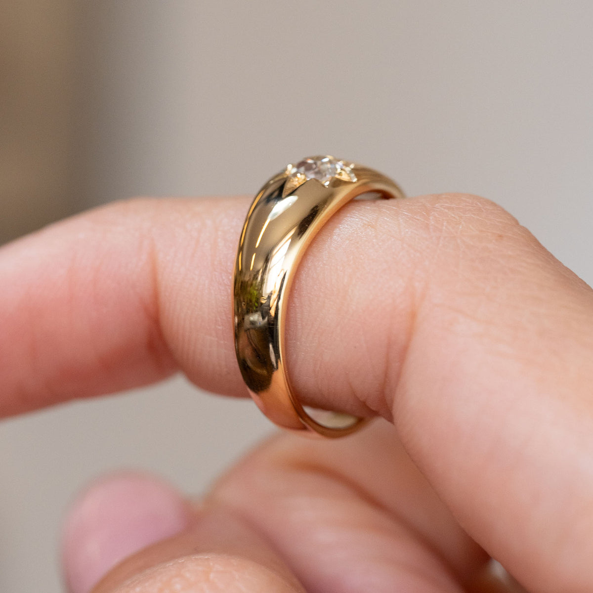 Side view of the antique engagement ring, showing the substantial gold band and low-profile diamond setting.