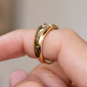 Side view of the antique engagement ring, showing the substantial gold band and low-profile diamond setting.