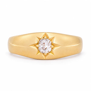 Antique Victorian diamond solitaire gypsy engagement ring in yellow gold, featuring a central diamond within an engraved star setting.