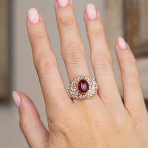 Asprey ruby and diamond cocktail ring worn on the hand, showcasing its bold statement scale and sculptural form.