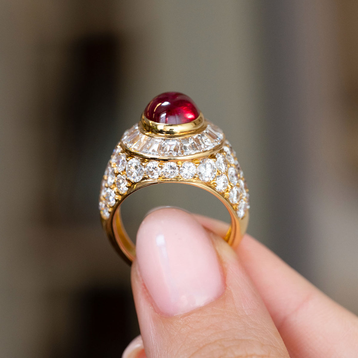 Reverse profile of the Asprey bombé ring, revealing the elevated ruby setting and diamond-covered yellow gold shoulders.