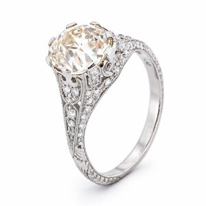 Three-quarter studio portrait of the Edwardian solitaire, showcasing its substantial old-mine diamond and intricate pierced setting.